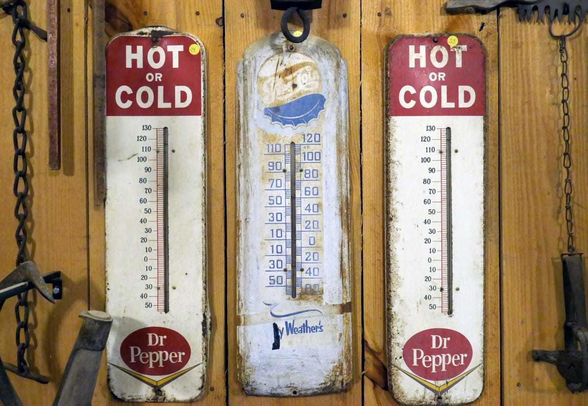 3 old thermometers on a wall